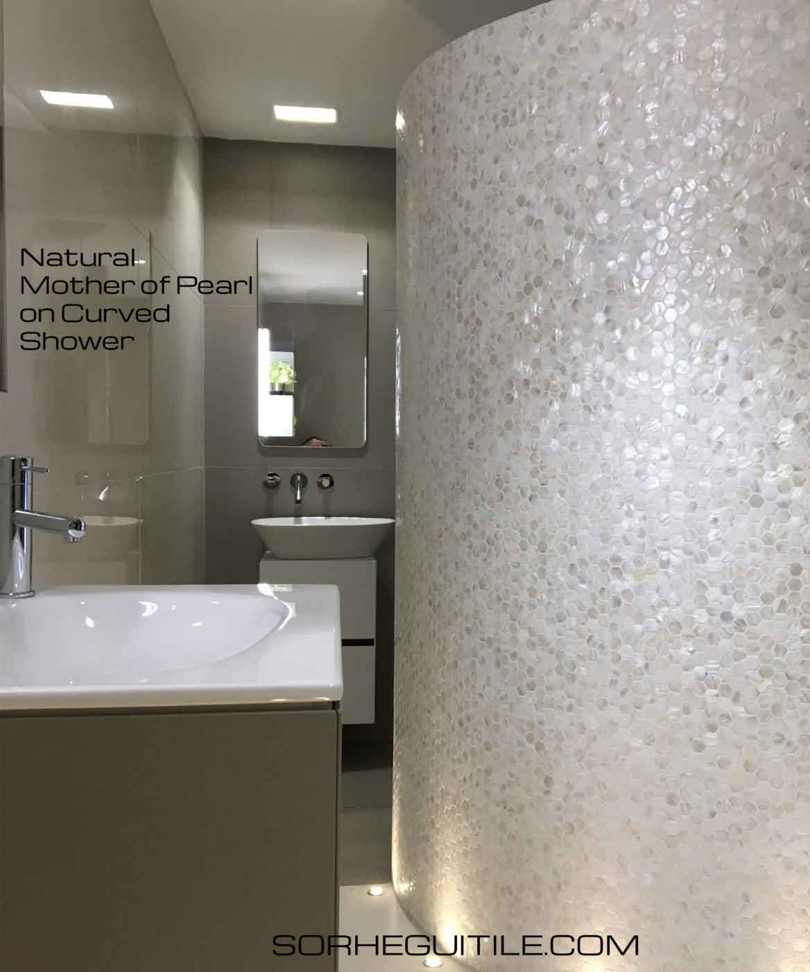 Bathroom with decorative, curbed wall of Siminetti Mother of Pearl Luxury Pearl Mosaic Tile from Ruben Sorhegui Tile Distributors Southwest Florida